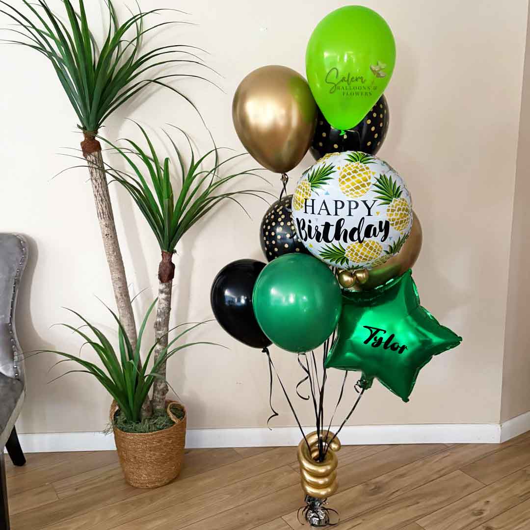 Birthday helium balloons, with a pina colada theme in green gold and black, with a personalized balloon with name. Birthday Balloon Delivery Salem ORegon