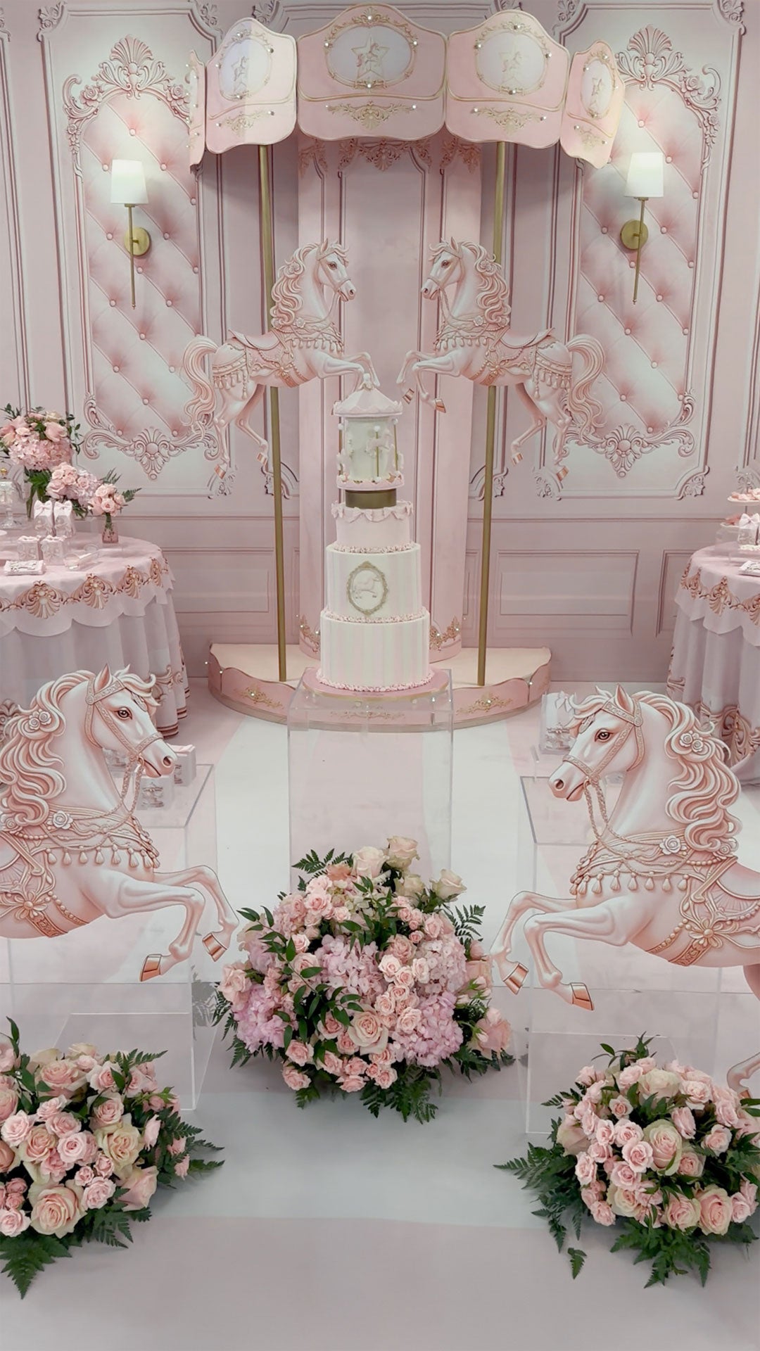 Pink carousel themed baby shower balloon decor, with 4 pink horses, flower arrangements, a large pink carousel with 2 pink horses and balloon garlands. Balloon decor. Oregon.