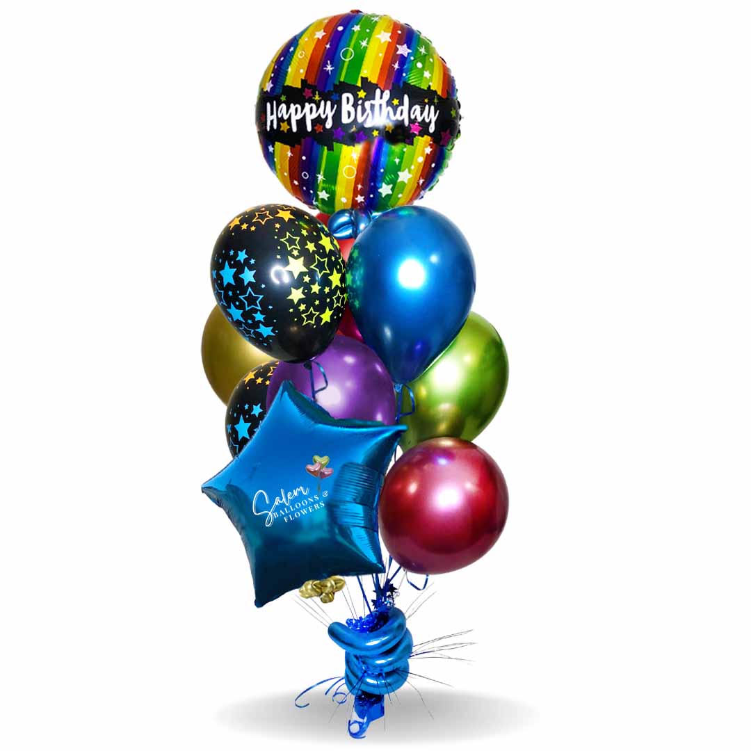 Rainbow colors helium filled balloons anchored to a decorated balloon weight. Birthday balloons Salem Oregon and nearby cities.