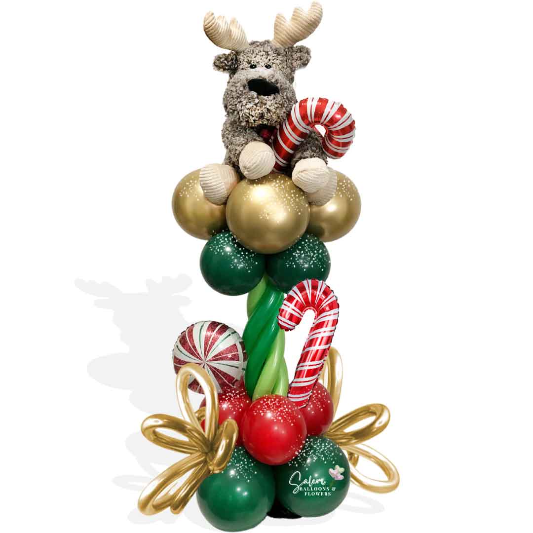 Christmas Balloons Salem ORegon. Christmas balloon column with a reindeer plush topper.
