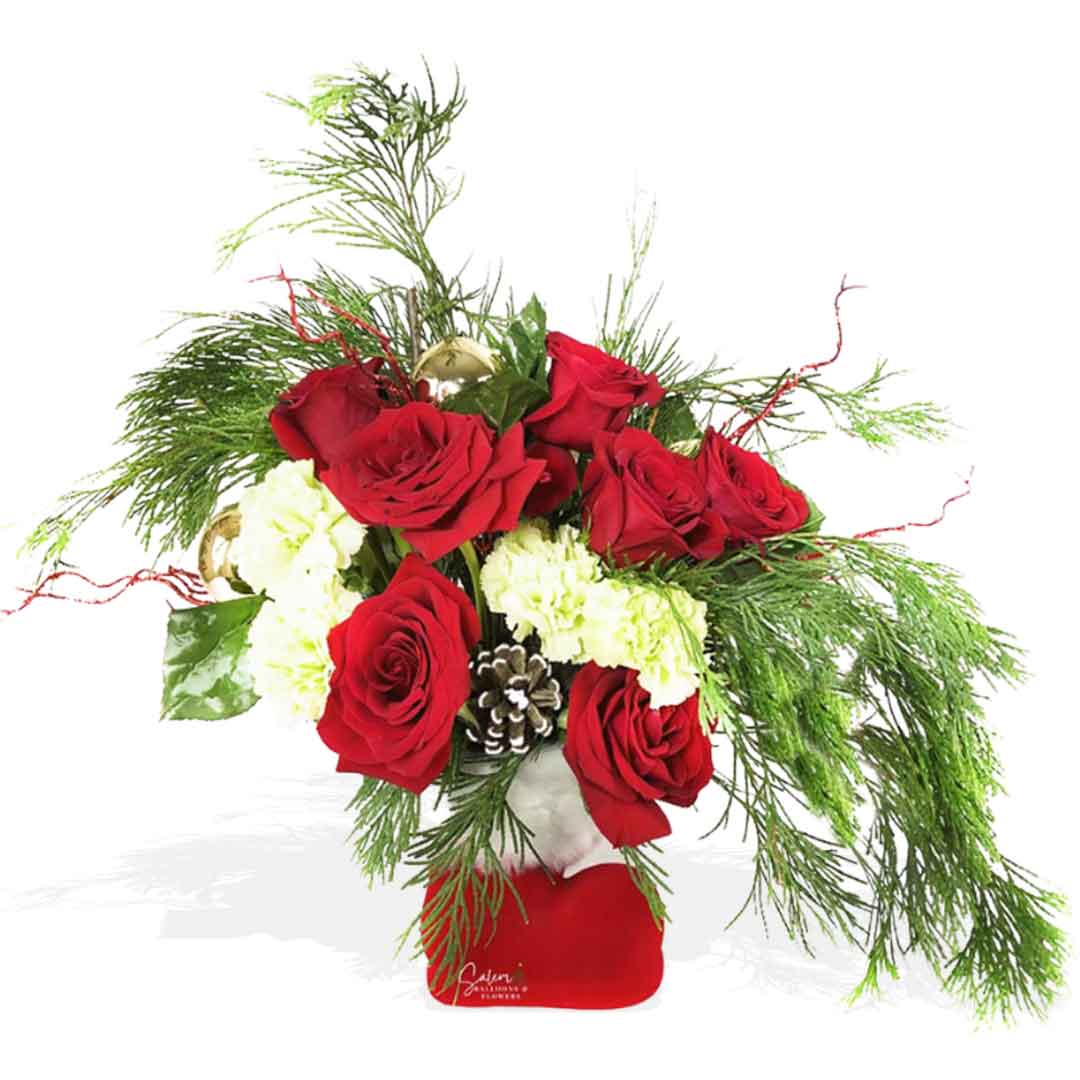 Red velvety Santa's boot vase filled with red roses, carnations, greenery, pine cones and Christmas ornaments. Christmas Flower delivery in Salem Oregon