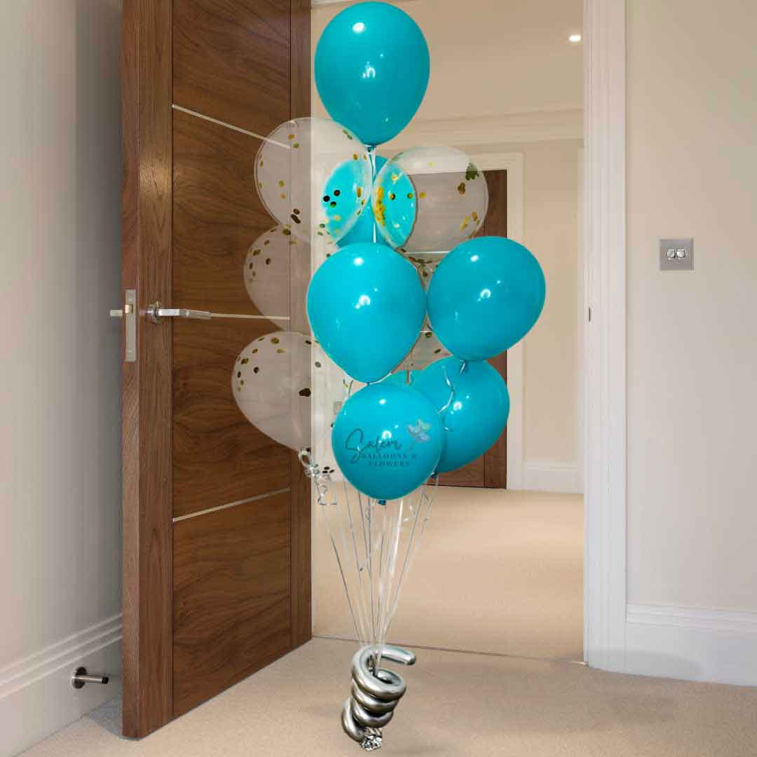 A 13 helium filled balloon bouquet in teal and golden confetti standing in 
front of a doorway. Oregon Balloon Delivery.