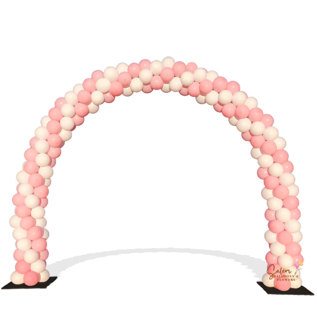 A traditional balloon arch with a spiral pattern in pink, white, and green colors, standing approximately 14 Ft wide by 10 Ft tall.