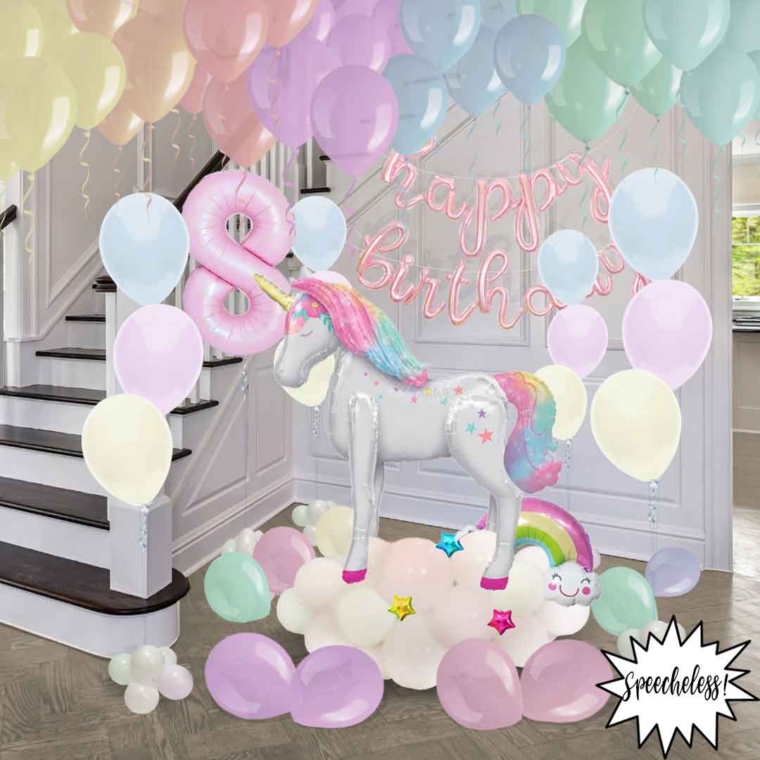 Unicorn themed balloon decoration, with helium balloons and an extra large balloon unicorn, balloon number, and ceiling helium balloons. Salem Oregon balloon decor.