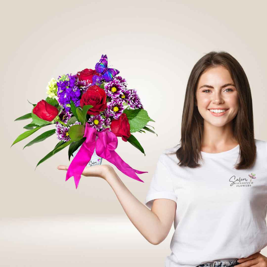 Girl holding a flower arrangement of  Roses, and daisies in a White vase. Flower delivery Salem Oregon