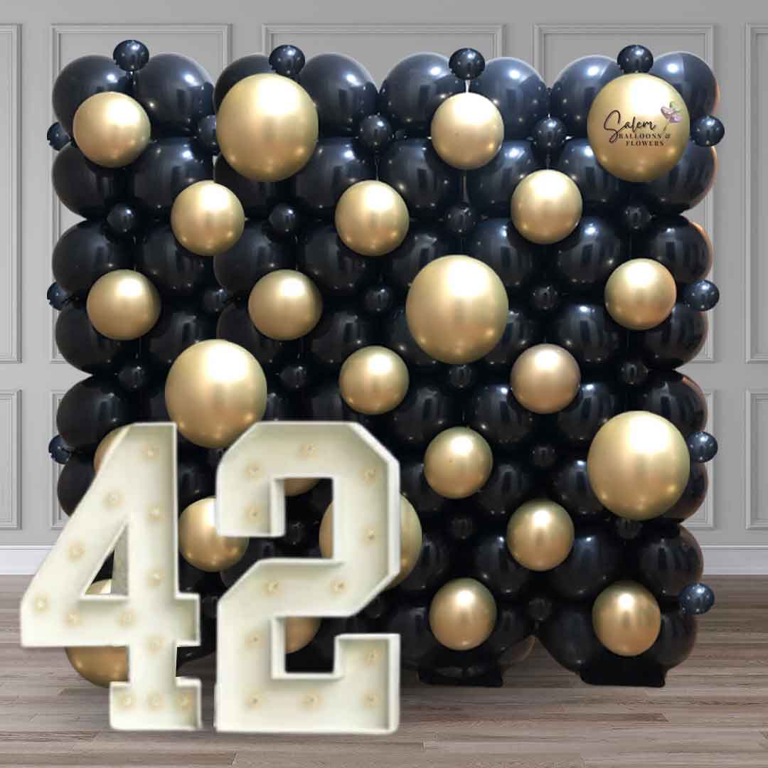 Photo backdrop. Black and gold Balloon wall with light up marquee numbers. Salem Oregon balloon decoration.