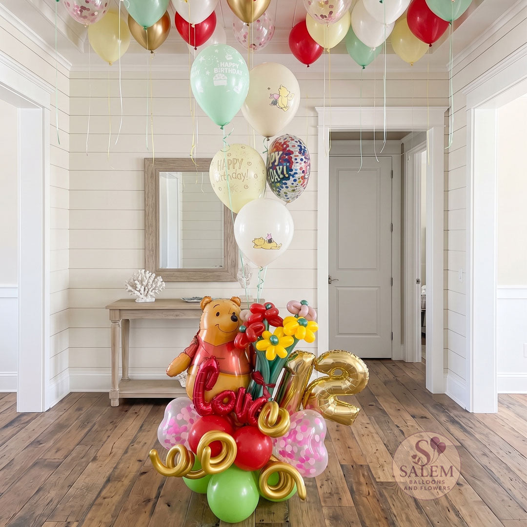 Un ramo de globos de cumpleaños de Pooh