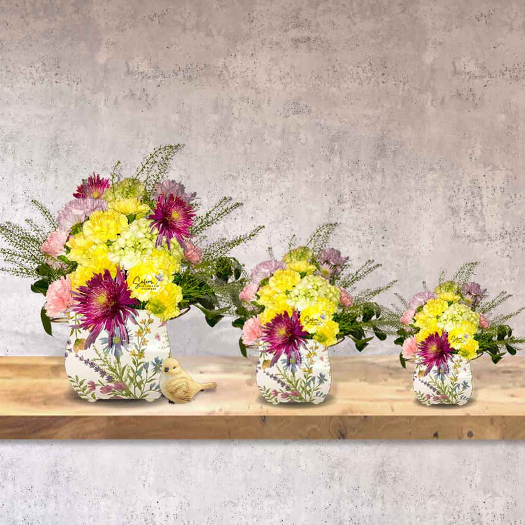Fresh flowers arranged in 3 square flower vases, small, medium and large, in pastel colors and decorated with a bird figurine. Salem Oregon Flower delivery