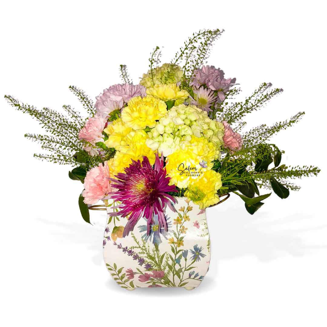 Fresh flowers arranged in a medium square flower vase in pastel colors and decorated with a bird figurine. Salem Oregon Flower delivery