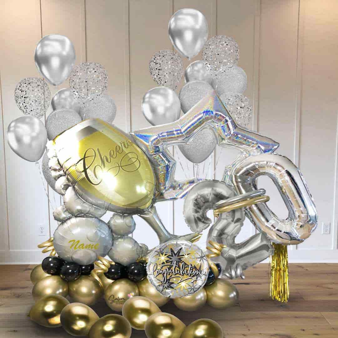 Large balloon bouquet decoration. Featuring a larch champagne glass with bubbles and balloon numbers. Balloons Salem Oregon