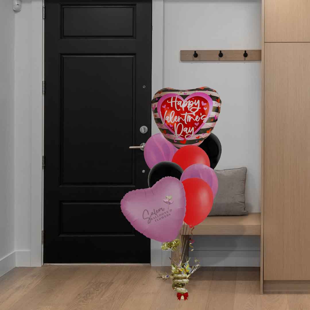 A Valentine's day Helium balloon bouquet in a hallway. Salem Oregon Balloon Delivery.