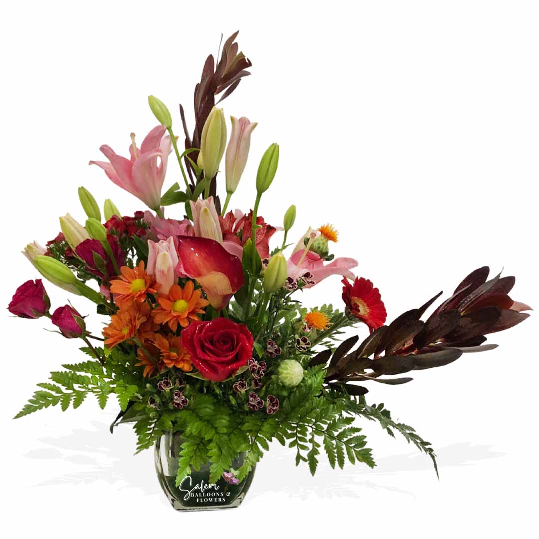 Flower arrangement with daisies, lilies, calas, gerberas, and roses in a glass vase. Flower delivery Salem Oregon.
