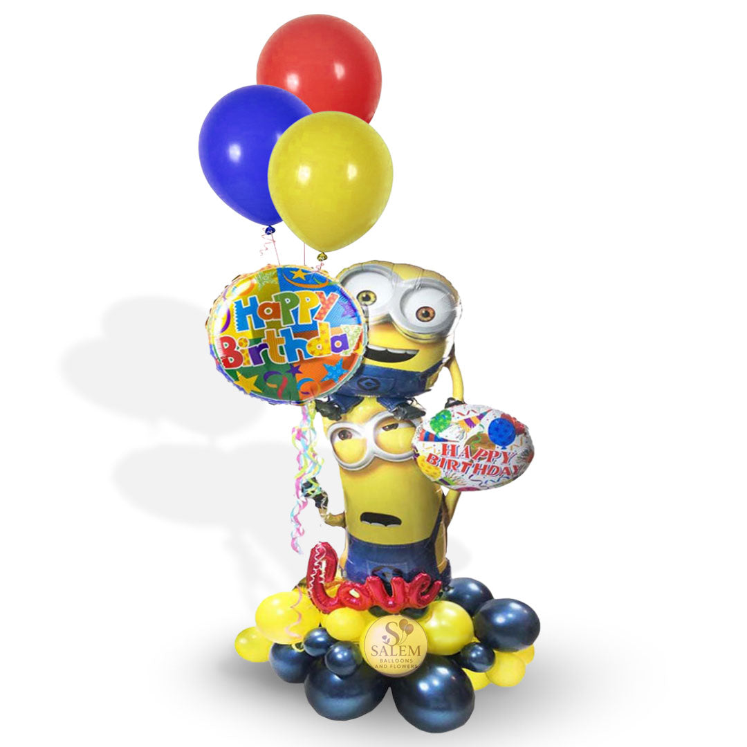 Custom Minions Happy Birthday balloon arrangement with foil Minion characters, colorful latex balloons, and a balloon base, available for delivery in Salem, Oregon from Salem Balloons and Flowers.