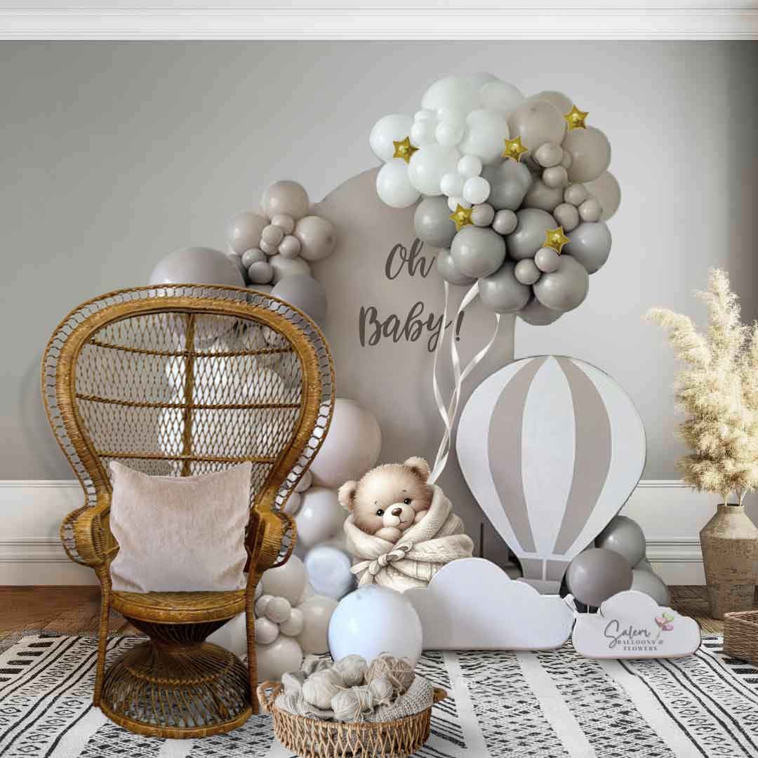 Teddy Bear balloon decor for baby shower. in a cream, gray and beige color palette. Decorated with a peacock wicker chair.  Balloon Decor Oregon.