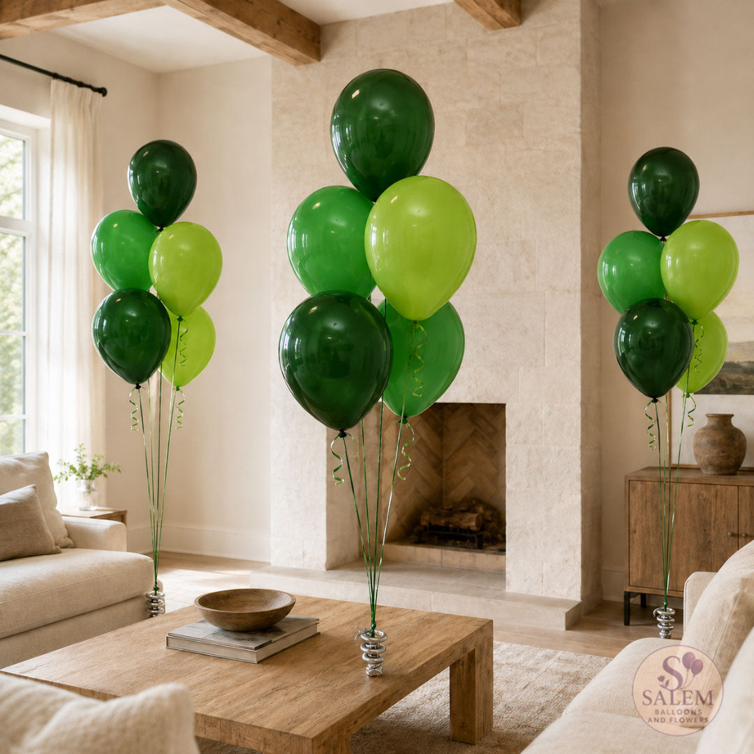 3 sert of helium filled balloon bouquets in green colors standing on a living room. Delivered by Salem Balloons and Flowers.