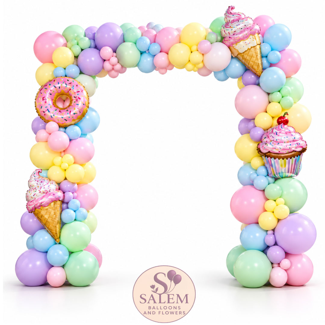 A pastel balloon arch decoration featuring a large arch made of pink, yellow, green, blue, and purple balloons, decorated with foil balloons shaped like ice cream cones, a donut with sprinkles, and a cupcake. A Salem Balloons and Flowers logo is visible at the bottom.