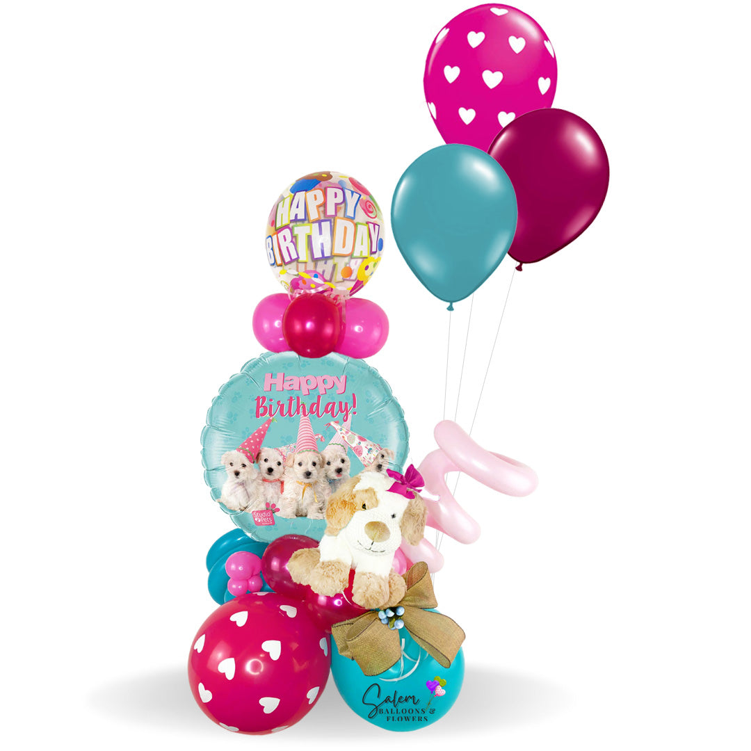 Birthday balloon bouquet. Featuring a Happy Birthday Mylar balloon with puppies wearing party hats and a cute puppy plush. Delivery available in Salem Oregon and nearby cities.
