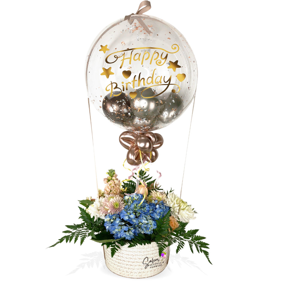 Flower delivery. Flower arrangement with a stuffed bubble balloon. Flower arrangement in a hot air shape. with teddy bear. Delivery available in Salem Oregon and nearby cities.