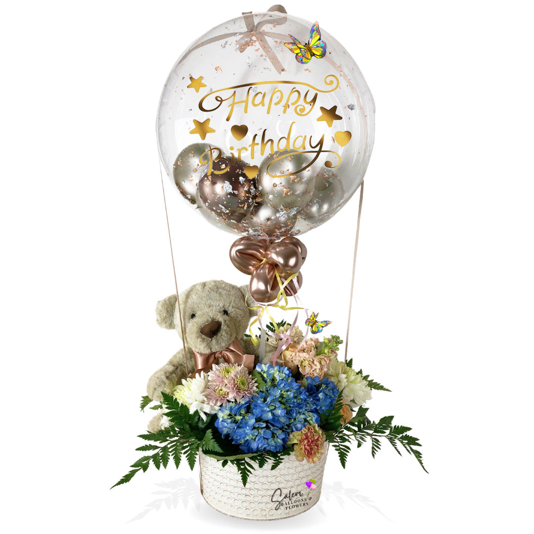Flower delivery. Flower arrangement with a stuffed bubble balloon. Flower arrangement in a hot air shape. with teddy bear. Delivery available in Salem Oregon and nearby cities.