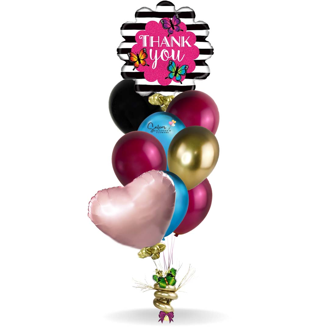 Thank You balloon bouquet. Featuring a black and white strips with colorful butterflies and a Thank You message balloon plus a set of colorful helium balloons anchored to a decorated weight. Deluxe style comes with a box of chocolates and free delivery.