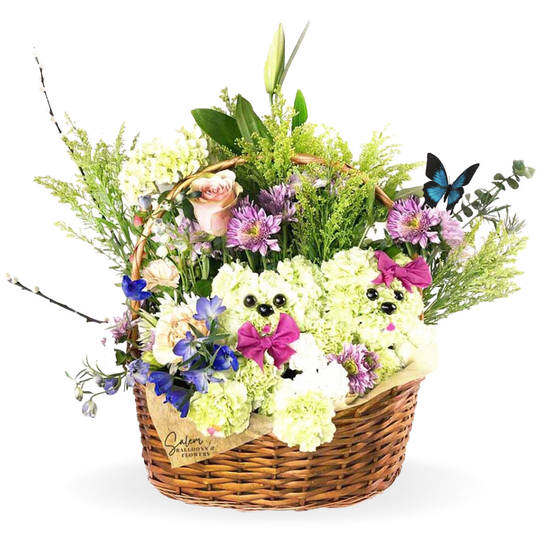 Basket flower arrangement. Featuring flower puppies poking out through the fresh beautiful flowers in a handcrafted basket. Awakening smiles and tender wiggles is easy with this playful Puppy Basket arrangement. A thoughtful gift for your favorite animal-lover! Free Delivery available in Salem Oregon and nearby areas.